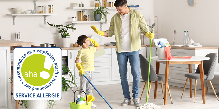 Father and son mopping floor in kitchen